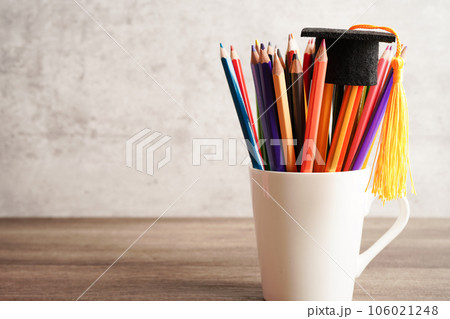 Graduation hat with colorful pencils on book with copy space, learning university education concept. 106021248