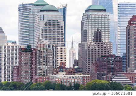 NEW YORK, USA - MAY 16, 2019: Skyline panorama of downtown Financial District and the Lower Manhattan with view to Battery Park and Empire state building NEW YORK, USA - MAY 16, 2019: Skyline panorama of downtown Financial District and the Lower Manhattan with view to Battery Park and Empire state building 106021681