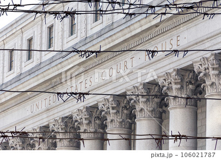 Barbed wire fence in front of United States Court House. Courthouse facade with columns, lower Manhattan, New York Barbed wire fence in front of United States Court House. Courthouse facade with columns, lower Manhattan, New York 106021787