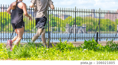 Healthy fit and sportive couple running in nature at summer day 106021805