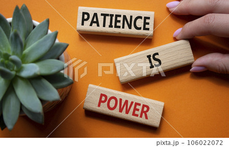 Patience is Power symbol. Concept words Patience is Power on wooden blocks. Beautiful orange background. Businessman hand. Business and Patience is Power concept. Copy space. Patience is Power symbol. Concept words Patience is Power on wooden blocks. Beautiful orange background. Businessman hand. Business and Patience is Power concept. Copy space. 106022072
