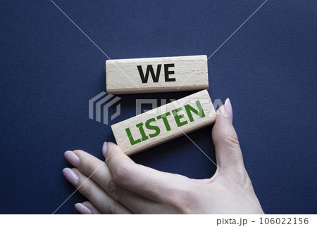 We listen symbol. Wooden blocks with words We listen. Businessman hand. Beautiful deep blue background. Business and We listen concept. Copy space. We listen symbol. Wooden blocks with words We listen. Businessman hand. Beautiful deep blue background. Business and We listen concept. Copy space. 106022156