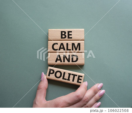 Be Calm and Polite symbol. Concept words Be Calm and Polite on wooden blocks. Businessman hand. Beautiful grey green background. Business and Be Calm and Polite concept. Copy space Be Calm and Polite symbol. Concept words Be Calm and Polite on wooden blocks. Businessman hand. Beautiful grey green background. Business and Be Calm and Polite concept. Copy space 106022508