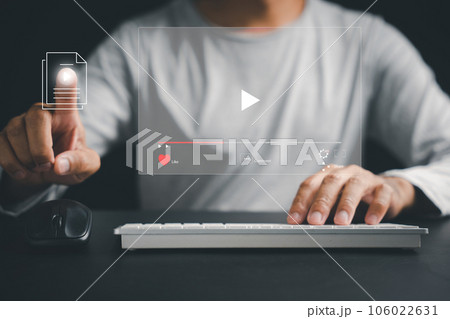 Step into the virtual dimension as a man's hand touches the screen, indulging in online videos, live concerts, and the cutting-edge concept of digital technology. 106022631