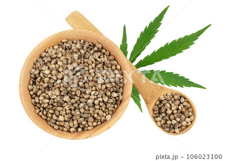 Hemp seeds in wooden bowl isolated on white background with full depth of field. Top view. Flat lay Hemp seeds in wooden bowl isolated on white background with full depth of field. Top view. Flat lay 106023100