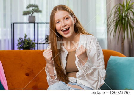 Excited happy young girl surprised shocked by sudden victory good win news celebrating game winning 106023768