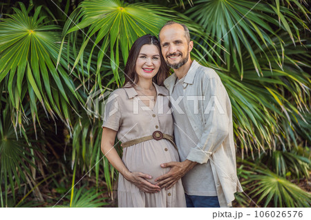 A blissful scene in the park as a radiant pregnant woman after 40 and her loving husband after 40, cherish the joy of parenthood together, surrounded by nature's serenity A blissful scene in the park as a radiant pregnant woman after 40 and her loving husband after 40, cherish the joy of parenthood together, surrounded by nature's serenity 106026576