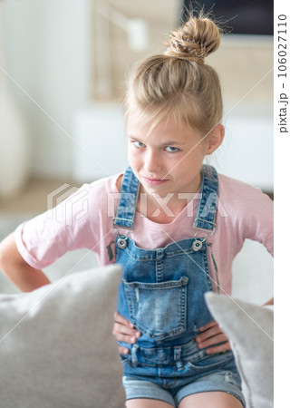 Portrait of blonde pre-Teenage Girl sitting on couch Portrait of blonde pre-Teenage Girl sitting on couch 106027110