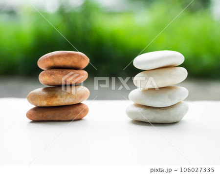 Stack Stone on White Table Background.Pyramid Rock Cairn,Pebble SPiritual,Stability,Calm,Meditation Growth Symbols,Pile Zen Design Smooth for Vacation Relaxation Nature Aroma therapy Spa Set Concept. Stack Stone on White Table Background.Pyramid Rock Cairn,Pebble SPiritual,Stability,Calm,Meditation Growth Symbols,Pile Zen Design Smooth for Vacation Relaxation Nature Aroma therapy Spa Set Concept. 106027335