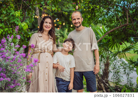 A loving family enjoying a leisurely walk in the park - a radiant pregnant woman after 40, embraced by her husband, and accompanied by their adult teenage son, savoring precious moments together A loving family enjoying a leisurely walk in the park - a radiant pregnant woman after 40, embraced by her husband, and accompanied by their adult teenage son, savoring precious moments together 106027831