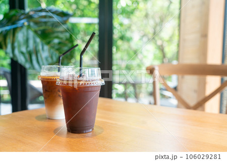 iced black coffee takeaway glass on table in coffee shop cafe restaurant 106029281