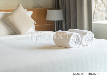 white towel on bed in bedroom 106029309