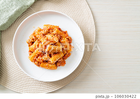 Rigatoni pasta bolognese with cheese 106030422