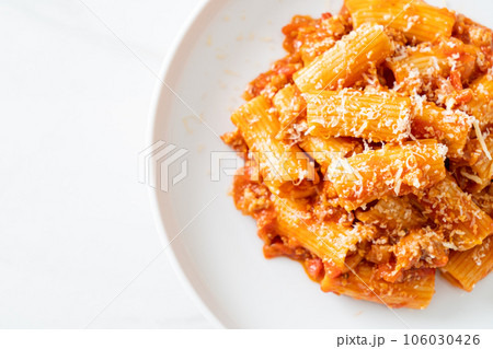 Rigatoni pasta bolognese with cheese 106030426