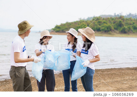 Group of Asian young people volunteer helping to collecting or picking up a plastic bottle garbage on the ground in park. Sustainability and environment conservation concept. Group of Asian young people volunteer helping to collecting or picking up a plastic bottle garbage on the ground in park. Sustainability and environment conservation concept. 106036269