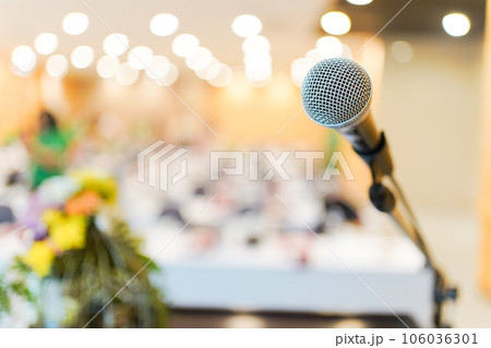 Wired microphone set up on the front of conference room close up with blurred background. Wired microphone close up with copy space background. Wired microphone set up on the front of conference room close up with blurred background. Wired microphone close up with copy space background. 106036301