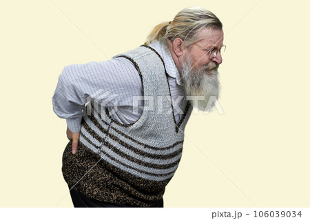 Aged long-bearded man suffering from back pain. Isolated on white. Aged long-bearded man suffering from back pain. Isolated on white. 106039034