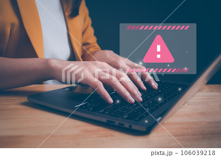 Businesswoman or programmer using computer laptop with triangle caution warning sign for notification error. Concept of computer virus detected, personal data protection, network security, maintenance 106039218