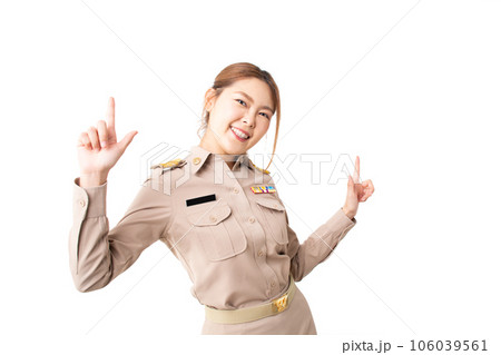 Female Thai government officer in khaki uniforms pointing up to product or empty copy space. Concept of advertising, presenting, promotion and satisfied product with isolated white background. 106039561