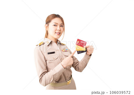 Female Thai government officer in khaki uniforms smiling and pointing on white background. Asian woman holding credit cards for transaction money. Concept of advertising, payment purchase, financial. Female Thai government officer in khaki uniforms smiling and pointing on white background. Asian woman holding credit cards for transaction money. Concept of advertising, payment purchase, financial. 106039572