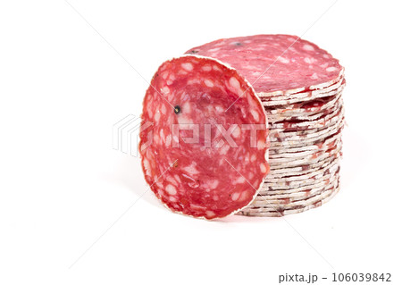 Slices of salami sausage on a white background 106039842