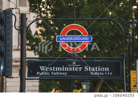 Sign board of Westminster Station in London. Public subway board of famous place. Red logo with Underground text on it. 106040205