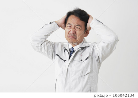 頭を抱えるミドルエイジの作業員 白背景 頭を抱えるミドルエイジの作業員 白背景 106042134
