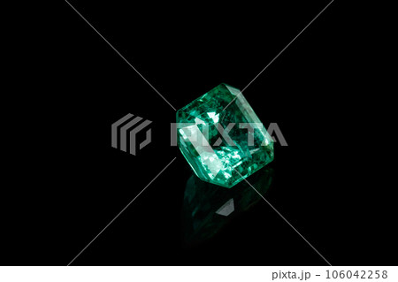 Macro mineral Emerald gemstone faceted on black background 106042258