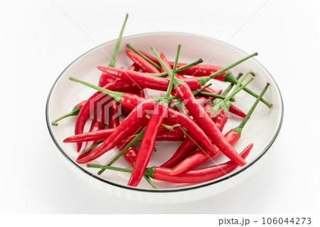 hot chili peppers in a bowl isolated on white hot chili peppers in a bowl isolated on white 106044273