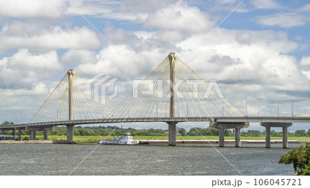 towboat with barges os passing under the Clark Bridge, a cable-stayed bridge across the Mississippi River between West Alton, Missouri and Alton, Illinois. 106045721