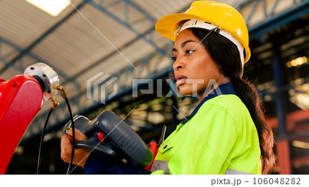 Technician engineer checking and repairing automatic robotic machine 106048282