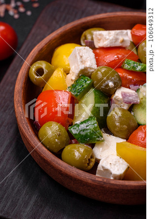 Delicious fresh, juicy Greek salad with feta cheese, olives, tomatoes, cucumber 106049312