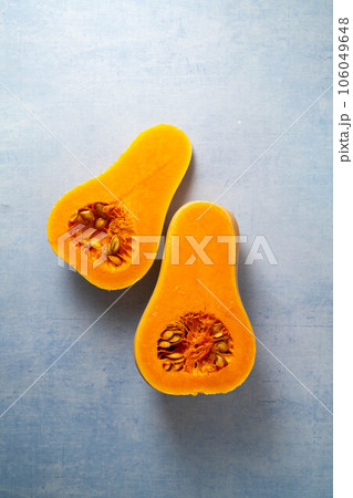 Butternut squash pumpkin and seeds on blue background Butternut squash pumpkin and seeds on blue background 106049648