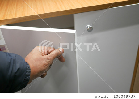 man's hand open drawer wooden in cabinet man's hand open drawer wooden in cabinet 106049737
