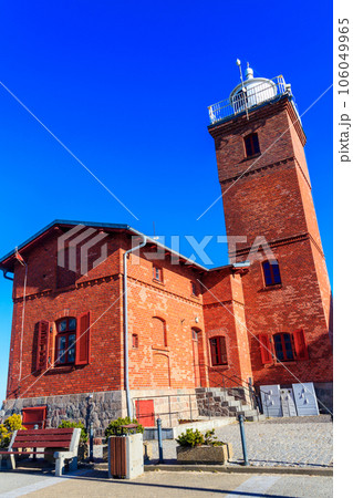 Old brick lighthouse at the Wieprza river mouth to the Baltic Sea in Darlowko, Poland 106049965