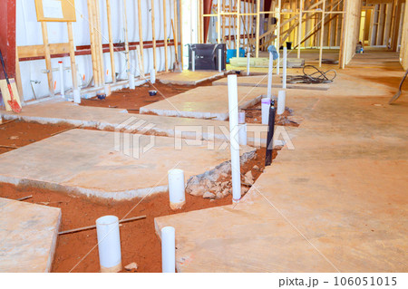 Plumbing preparation pvc pipe endings exposed in concrete floor for future lavatory a restroom 106051015