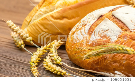 Concept of abundance and harvest, bread and ears of wheat. Concept of abundance and harvest, bread and ears of wheat. 106051655