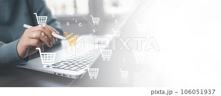 Businessman using a laptop with online shopping concept, marketplace website with virtual interface of online Shopping cart part of the network, Online shopping business with selecting shopping cart. Businessman using a laptop with online shopping concept, marketplace website with virtual interface of online Shopping cart part of the network, Online shopping business with selecting shopping cart. 106051937