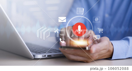 Businessman using smartphone touch microphone button on virtual screen. Blog blog speak talk advertising presentation,Voice recognition, speech detection and deep learning application,Voice Assistance Businessman using smartphone touch microphone button on virtual screen. Blog blog speak talk advertising presentation,Voice recognition, speech detection and deep learning application,Voice Assistance 106052088