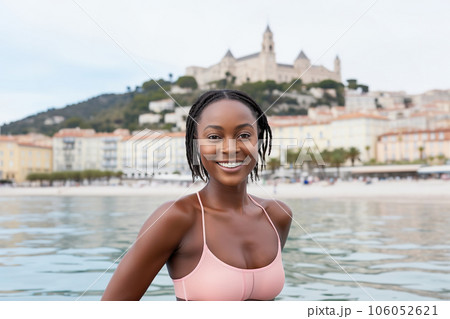Young black woman swimming in sea, smiling. Summer vacation in Europe Young black woman swimming in sea, smiling. Summer vacation in Europe 106052621