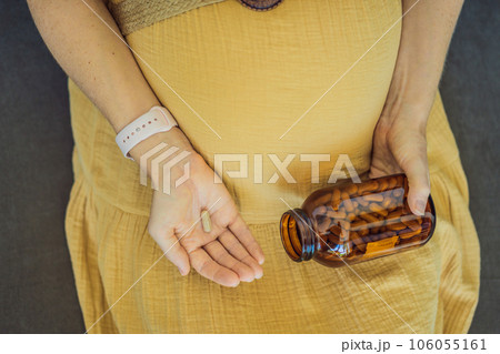 Prenatal Vitamins. Portrait Of Beautiful Smiling Pregnant Woman Holding Transparent Glass Jar With Pills, Taking Supplements For Healthy Pregnancy While Sitting On Couch At Home, Free Space Prenatal Vitamins. Portrait Of Beautiful Smiling Pregnant Woman Holding Transparent Glass Jar With Pills, Taking Supplements For Healthy Pregnancy While Sitting On Couch At Home, Free Space 106055161