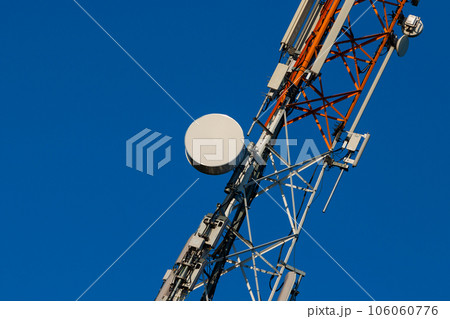 Communications tower with antennas on blue sky 106060776