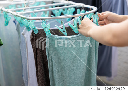 洗濯物をベランダで干している若い女性 洗濯物をベランダで干している若い女性 106060990