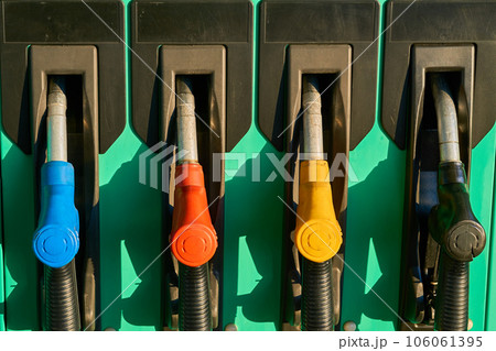A refueling gun wakes up a car at a gas station. A refueling gun wakes up a car at a gas station. 106061395