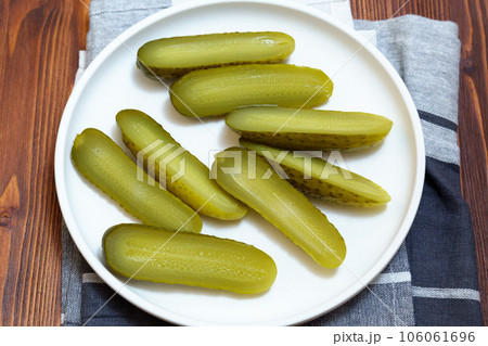 Pickled cucumbers close-up, snack. Selective focus. Ingredients for cooking on a wooden table. Pickled cucumbers close-up, snack. Selective focus. Ingredients for cooking on a wooden table. 106061696