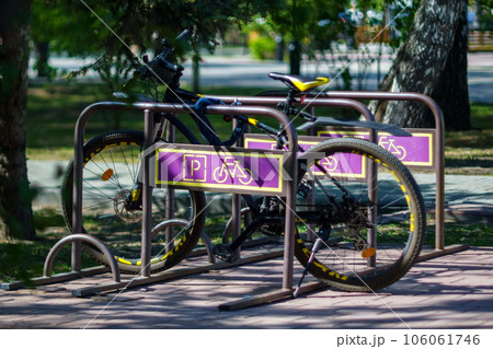 Bicycle parking in the parking lot. Summer day, selective focus Bicycle parking in the parking lot. Summer day, selective focus 106061746