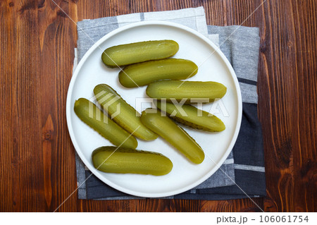 Pickled cucumbers close-up, snack. Selective focus. Ingredients for cooking on a wooden table Pickled cucumbers close-up, snack. Selective focus. Ingredients for cooking on a wooden table 106061754