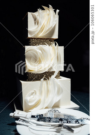 Premium square form wedding cake three floors at the evening ceremony Premium square form wedding cake three floors at the evening ceremony 106065301