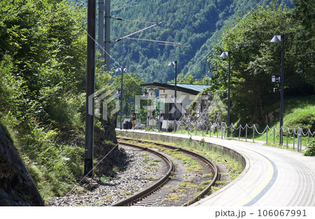 山々に囲まれたオーストリアにあるハルシュタット駅のホームで電車を待つ人たち（人物の顔ぼかし） 106067991