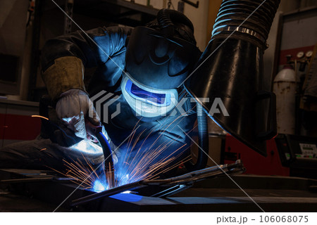 welder is welding metal part in car factory welder is welding metal part in car factory 106068075